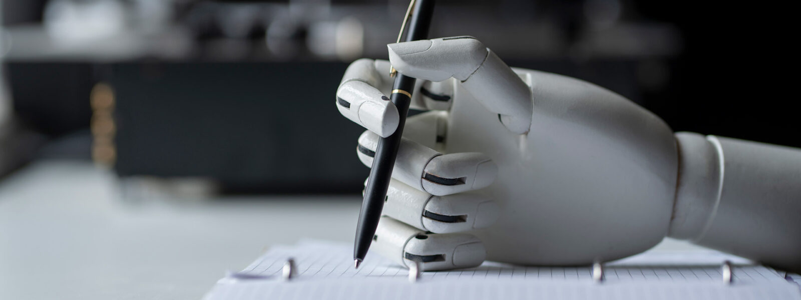 Artificial robotic arm writing down some notes